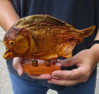 #2 Grade 9 inch Real dried Piranha Fish from South America on a wood display base (You are buying the piranha shown) for $35.00 (damaged tail - will have some tiny small holes in the skin)