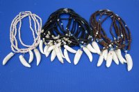 Wholesale Alligator tooth necklace 2 to 2-3/8 inch wrapped with silver colored wire on an assorted color coconut bead necklace - Packed: 2 pcs @ $8.50 each, Packed: 10 @ $7.50 each 